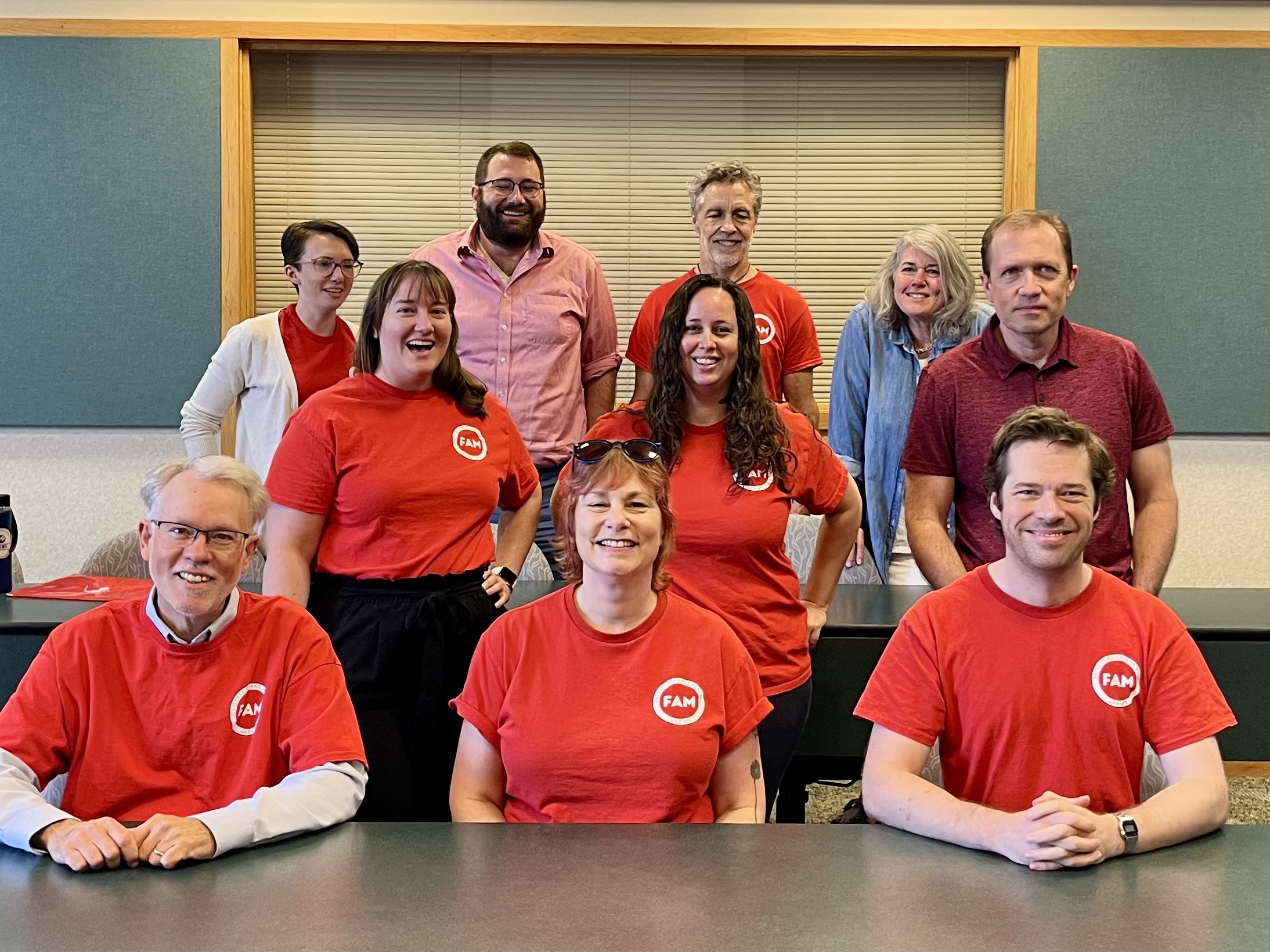 FAM NT smiling confidently in red FAM shirts