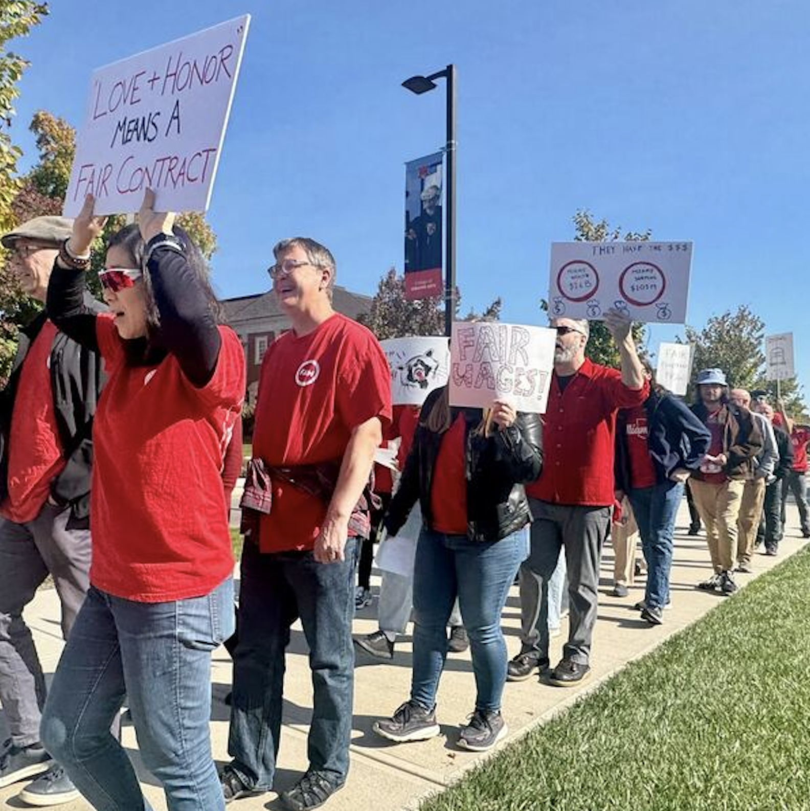 a line of FAM members holding signs at October 18's Practice Picket