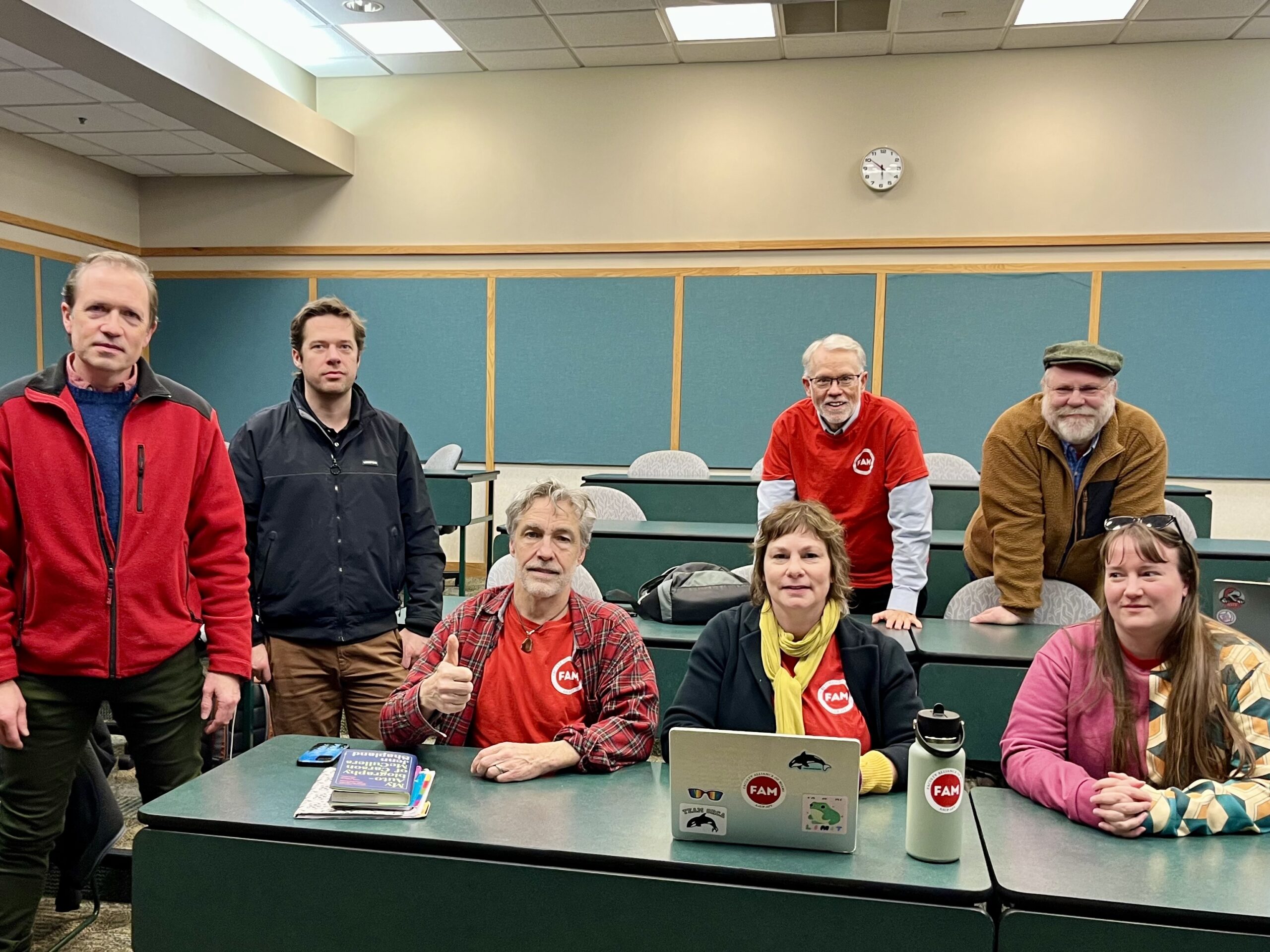 Red-shirted NT members, smiling in caucus